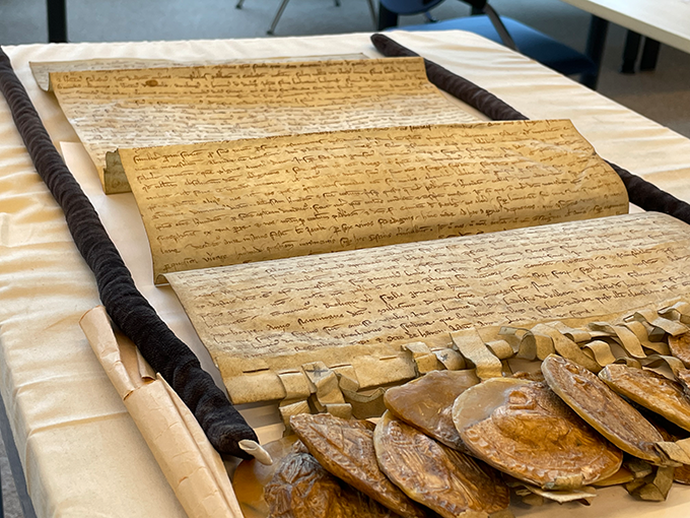 Eine historische Urkunde mit Wachssiegeln.